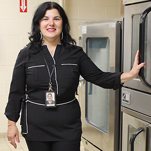 Woman poses for photo in kitchen