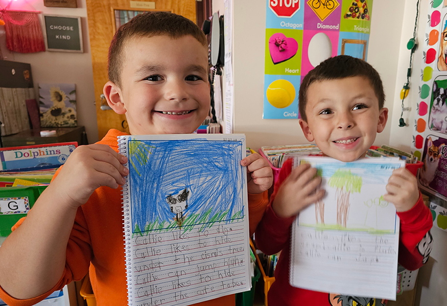 Two students show off their writing