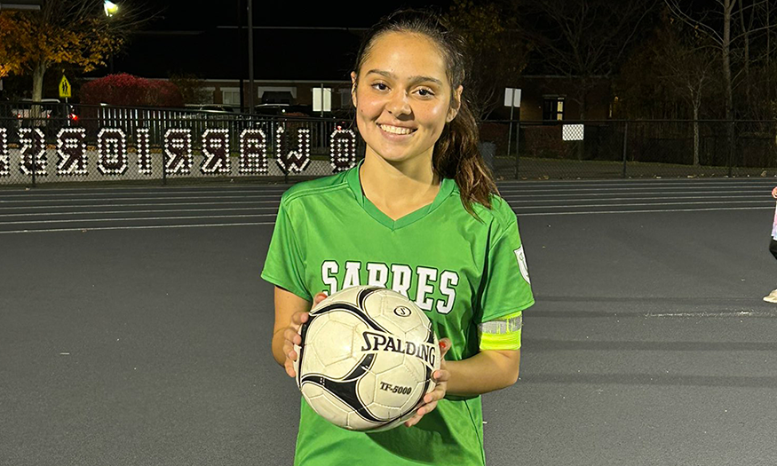 Student-athlete holding soccer ball