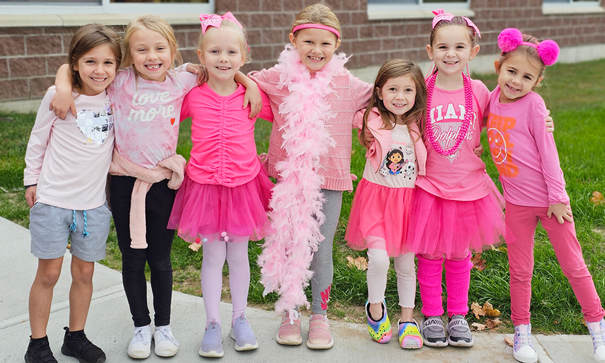 Students line up for photo dressed in pink