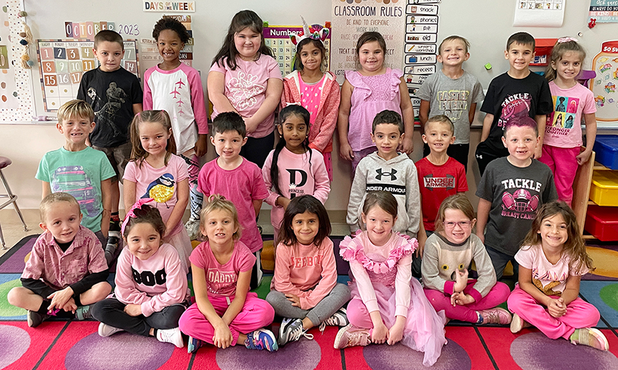 Students line up for photo dressed in pink