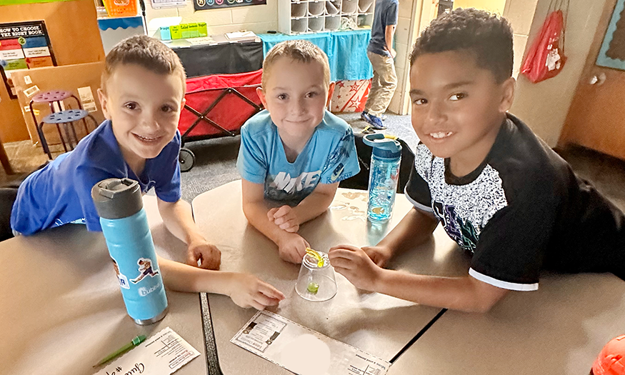 Three students excited about science project