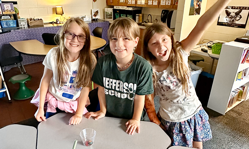 Three students excited about science project