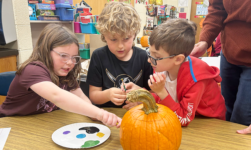 Students work on pumpkin