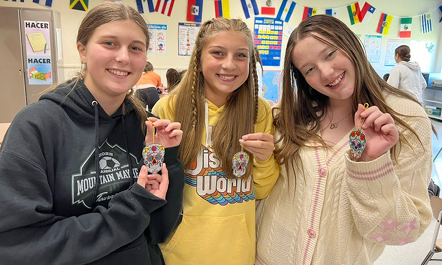 Group photo of students holding skull decorations