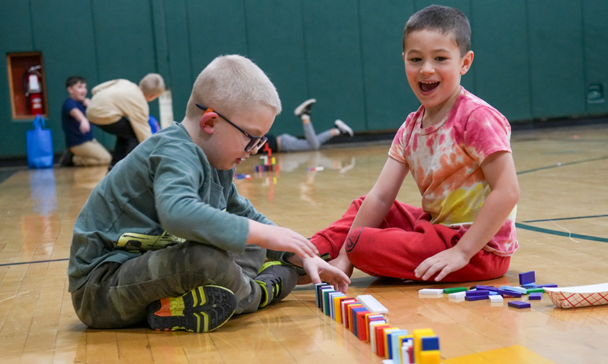 Students have fun with dominoes