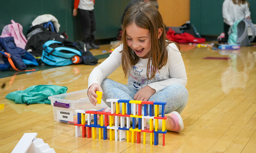 Student has fun with dominoes