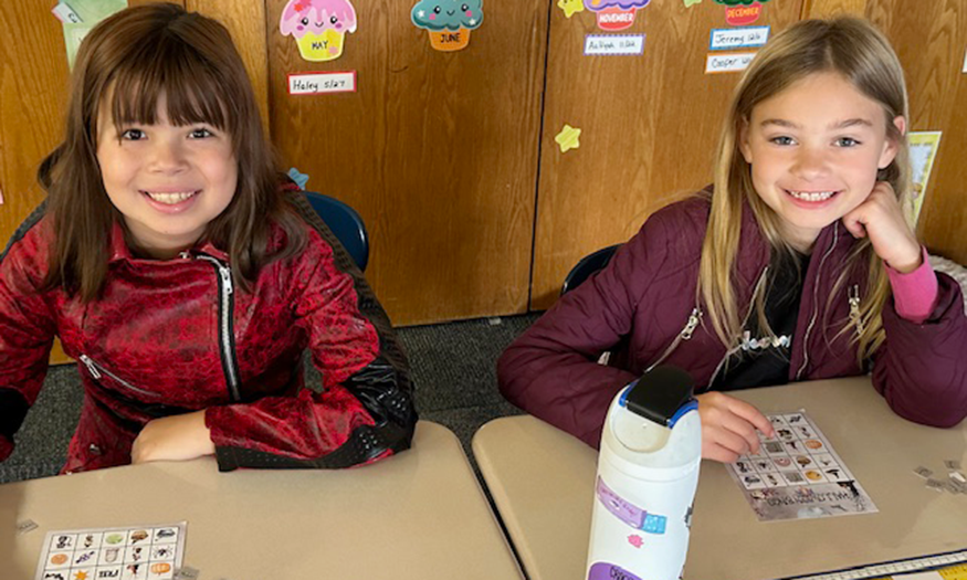 Two students pose for photo