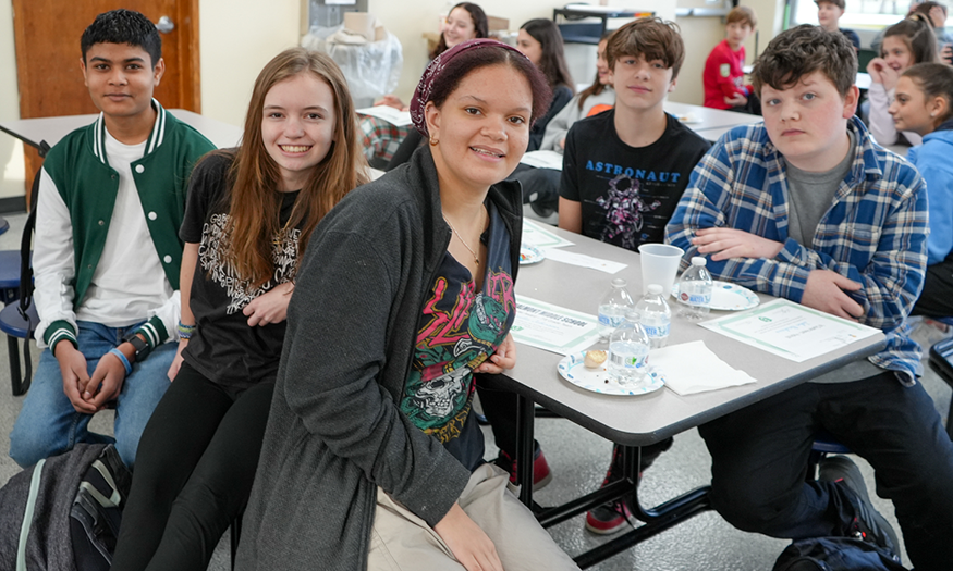 Students pose for photo at lunch table