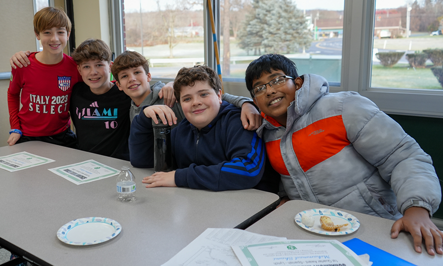Students pose for photo at lunch table