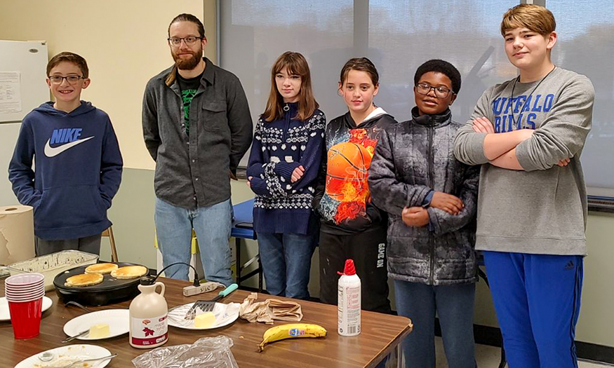 Group photo of students behind table