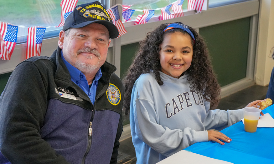 Veteran and student pose for photo