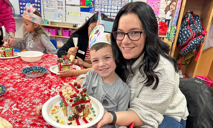 Mother and son with gingerbread house