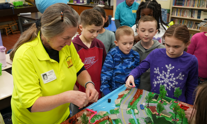 Students gather around model