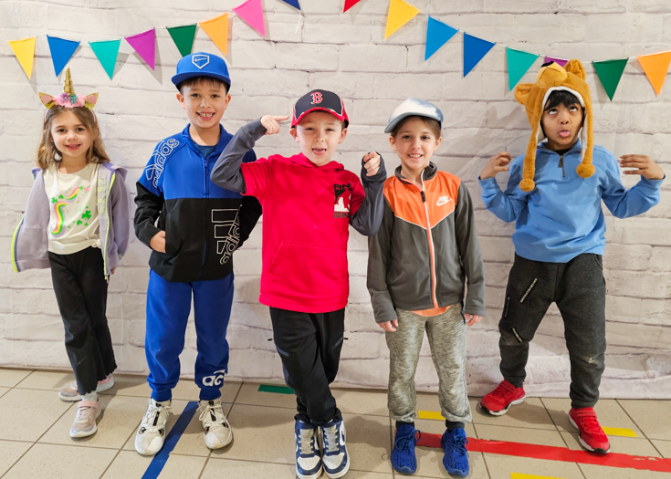 Students in hats pose for photo