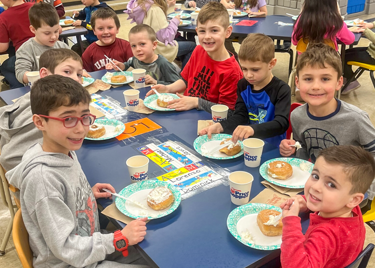 Students sit together at table