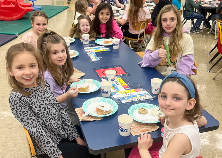 Students sit together at table