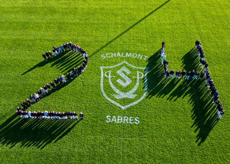 Overhead photo of students spelling out 24