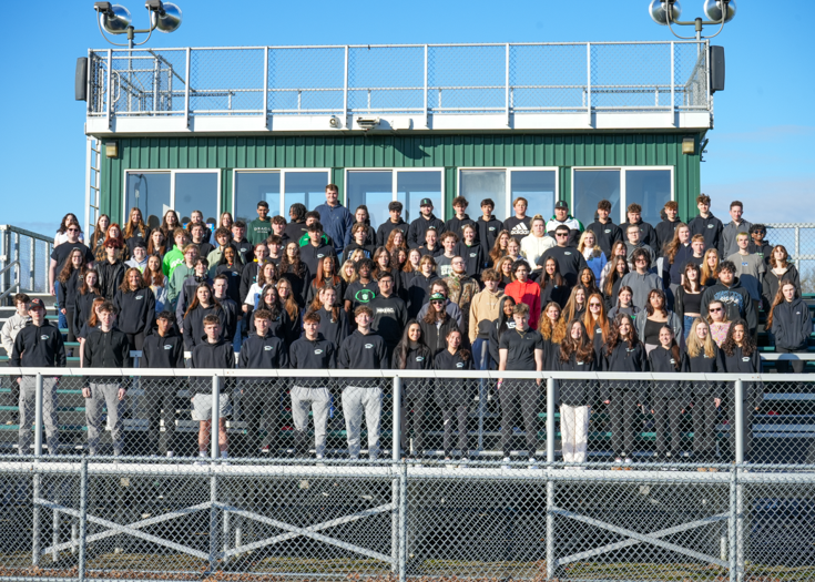Group photo of students on bleachers