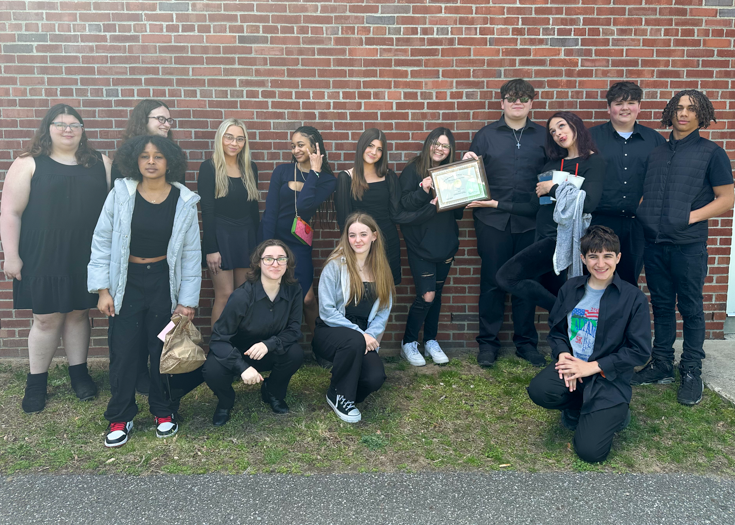 Group photo of students with award