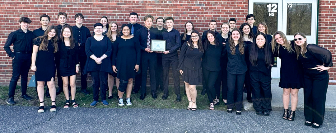 Group photo of students with award