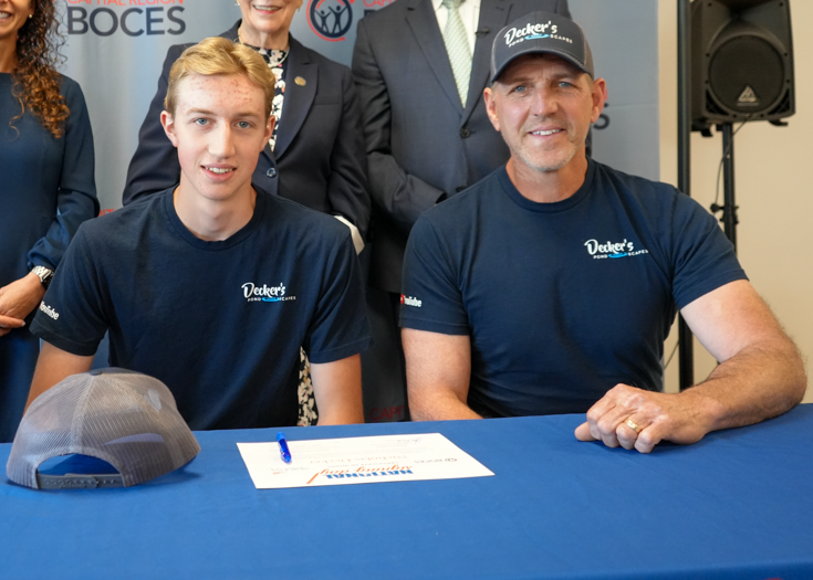 Group photo of father and son at table