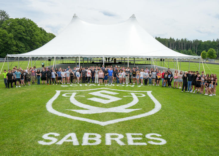 Group photo of students on field