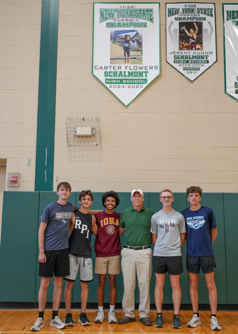 Athletes and coach pose for photo