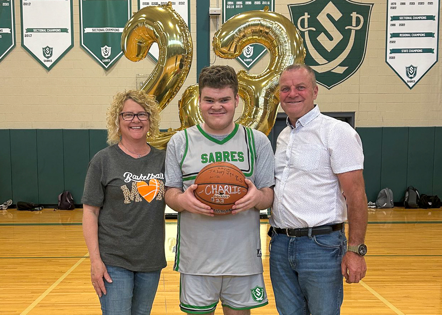 Family poses for photo on Senior Night
