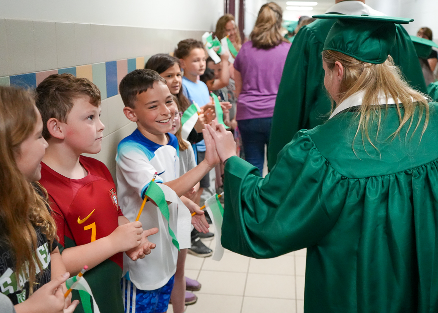Senior high fives student