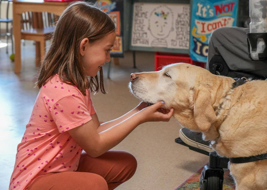 Student pets service dog