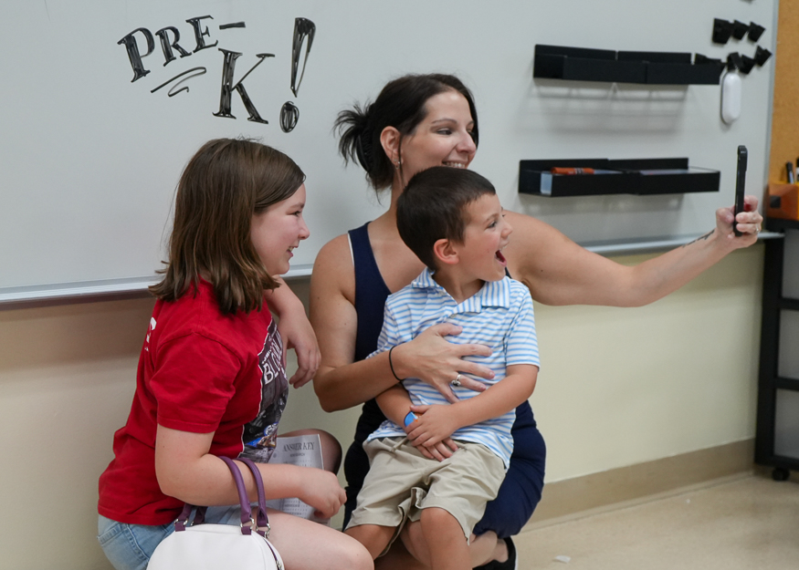 Family takes a selfie in classroom