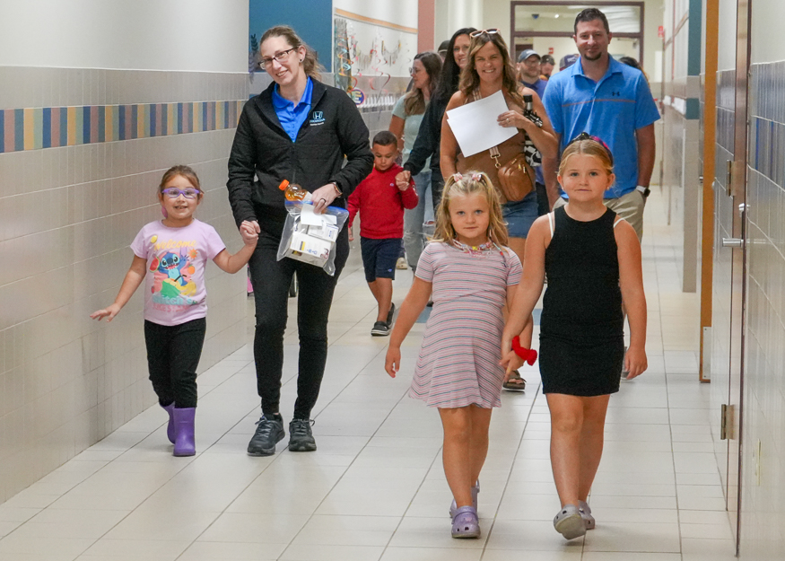 Families walk in hallway