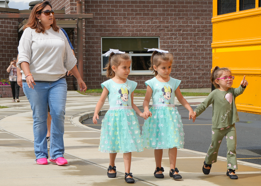 Students walk near bus