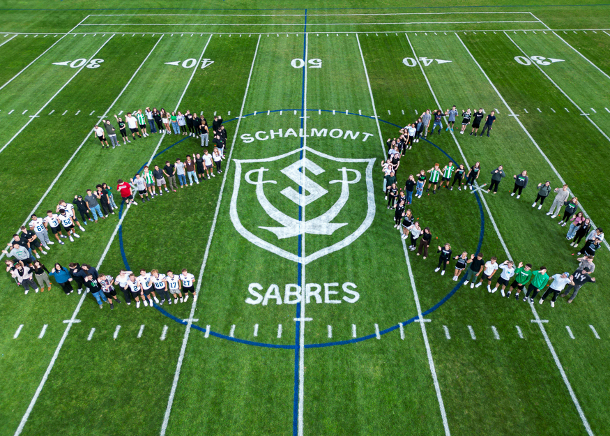 Group photo of students in shape of 26