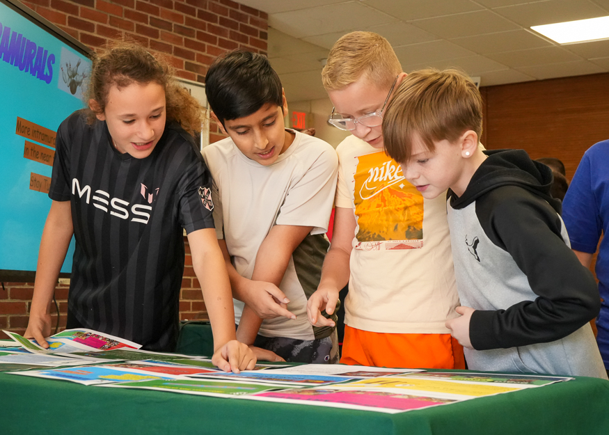 Students look at brochures