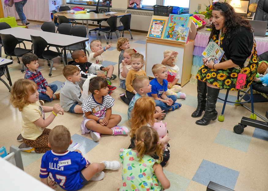Teacher talks to young students