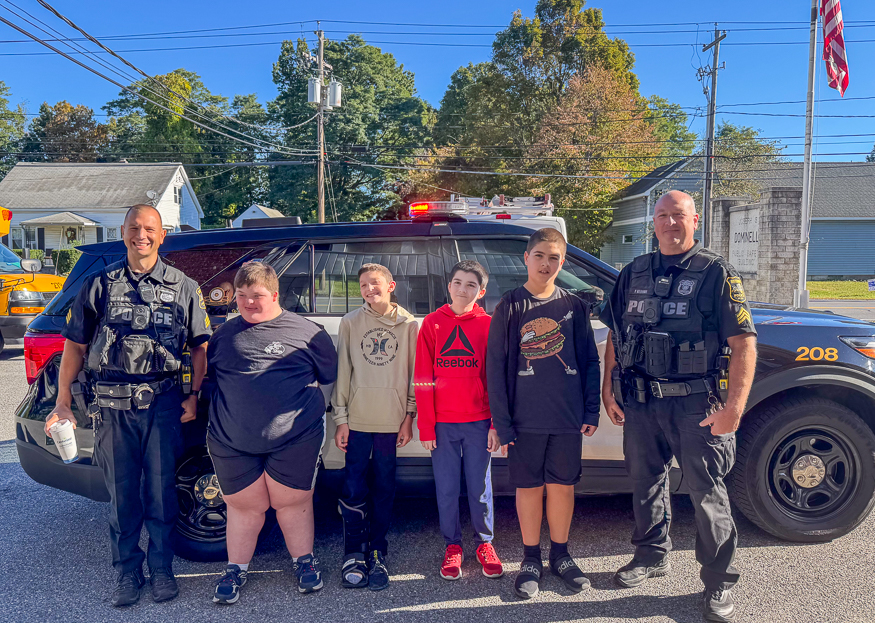 Students pose for photo with officers