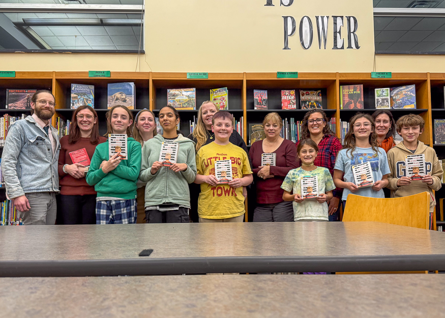 Group photo of families holding books