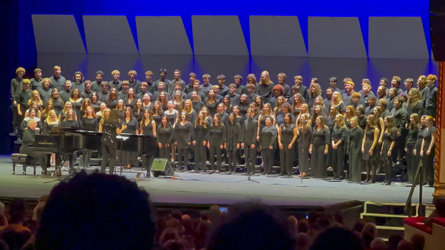 Students sing on stage