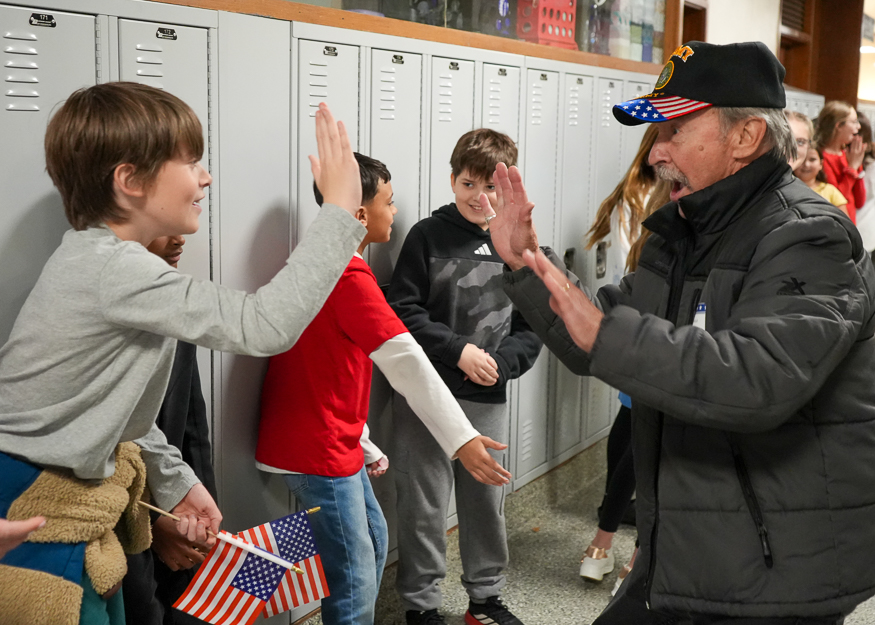 Veteran high fives student