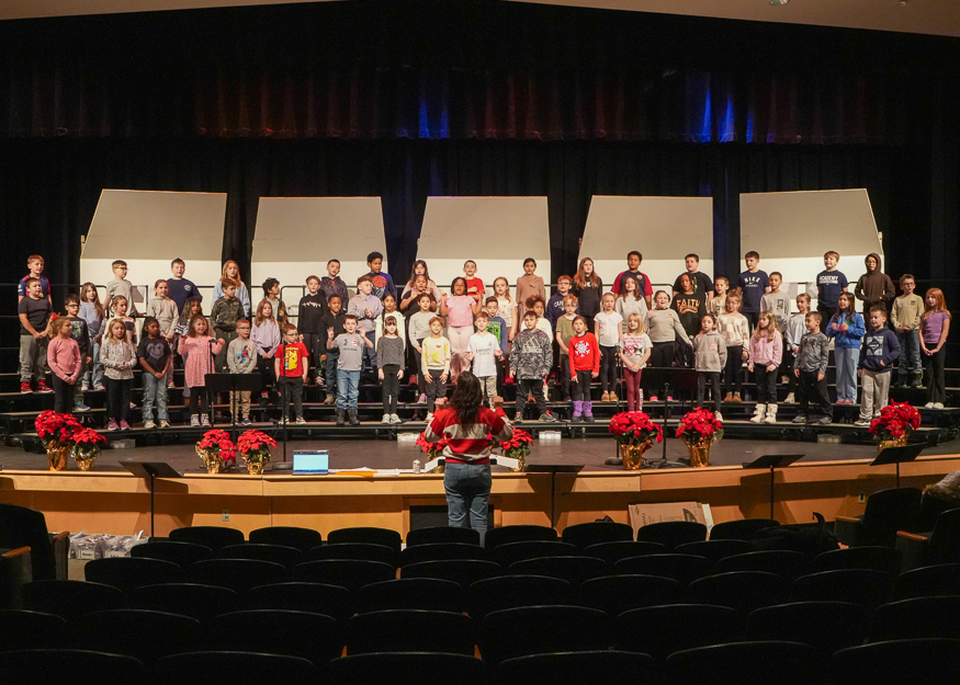 Students rehearse on stage for concert