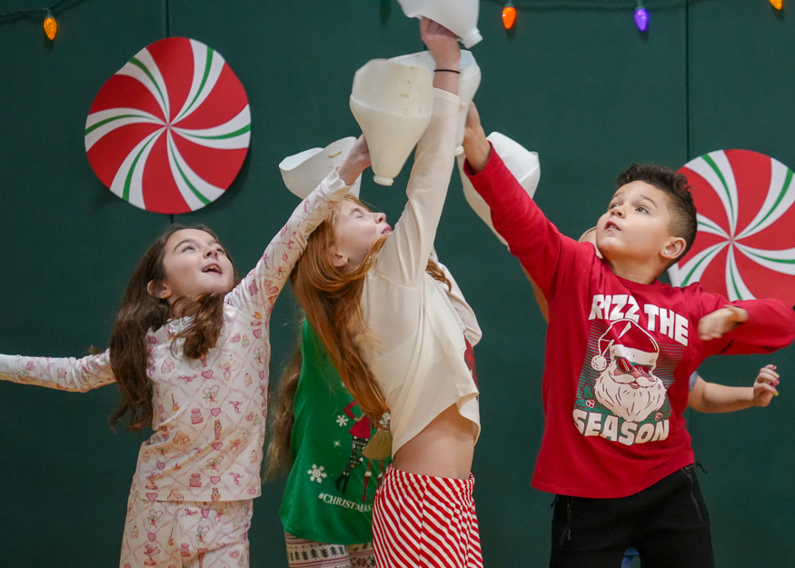 Students jump for ball in PE