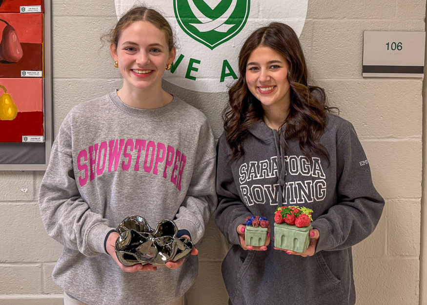 Students pose with sculptures