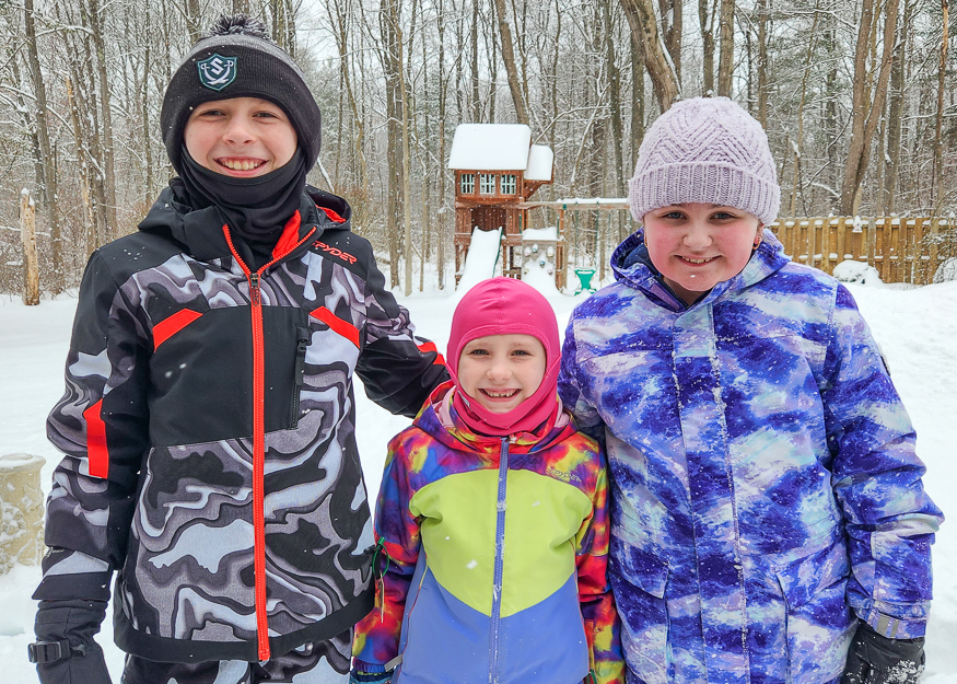 Students pose for photo in snow