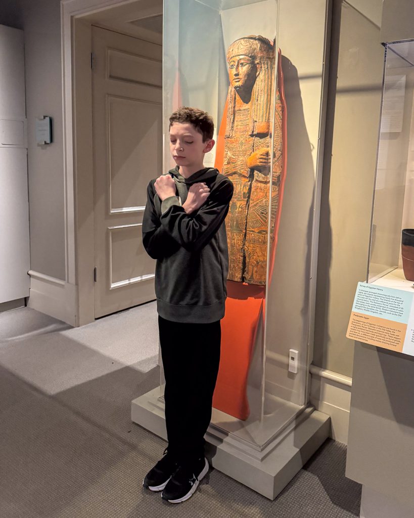 Student in front of mummy exhibit