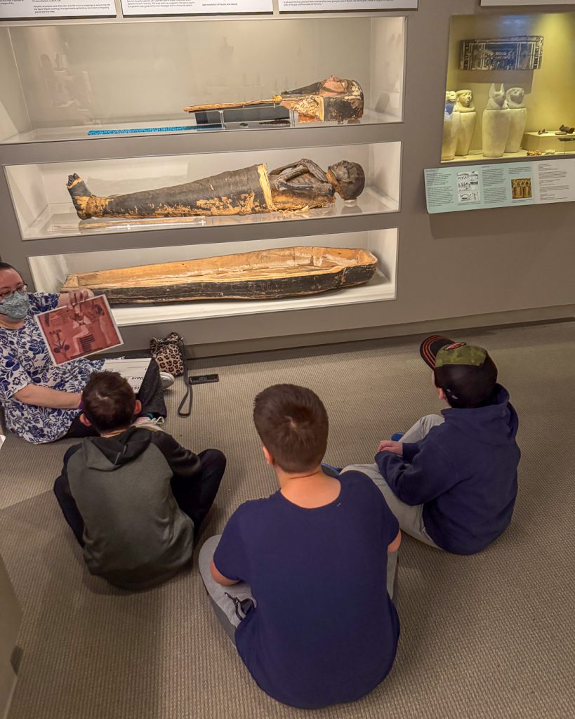 Students in front of mummy exhibit