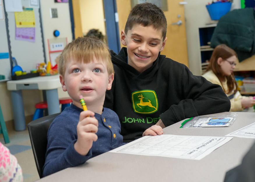 Students work together at desk