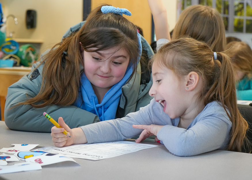 Students work together at desk