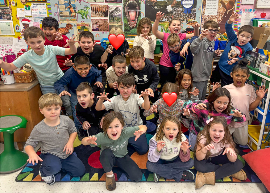 Young students make dinosaur faces